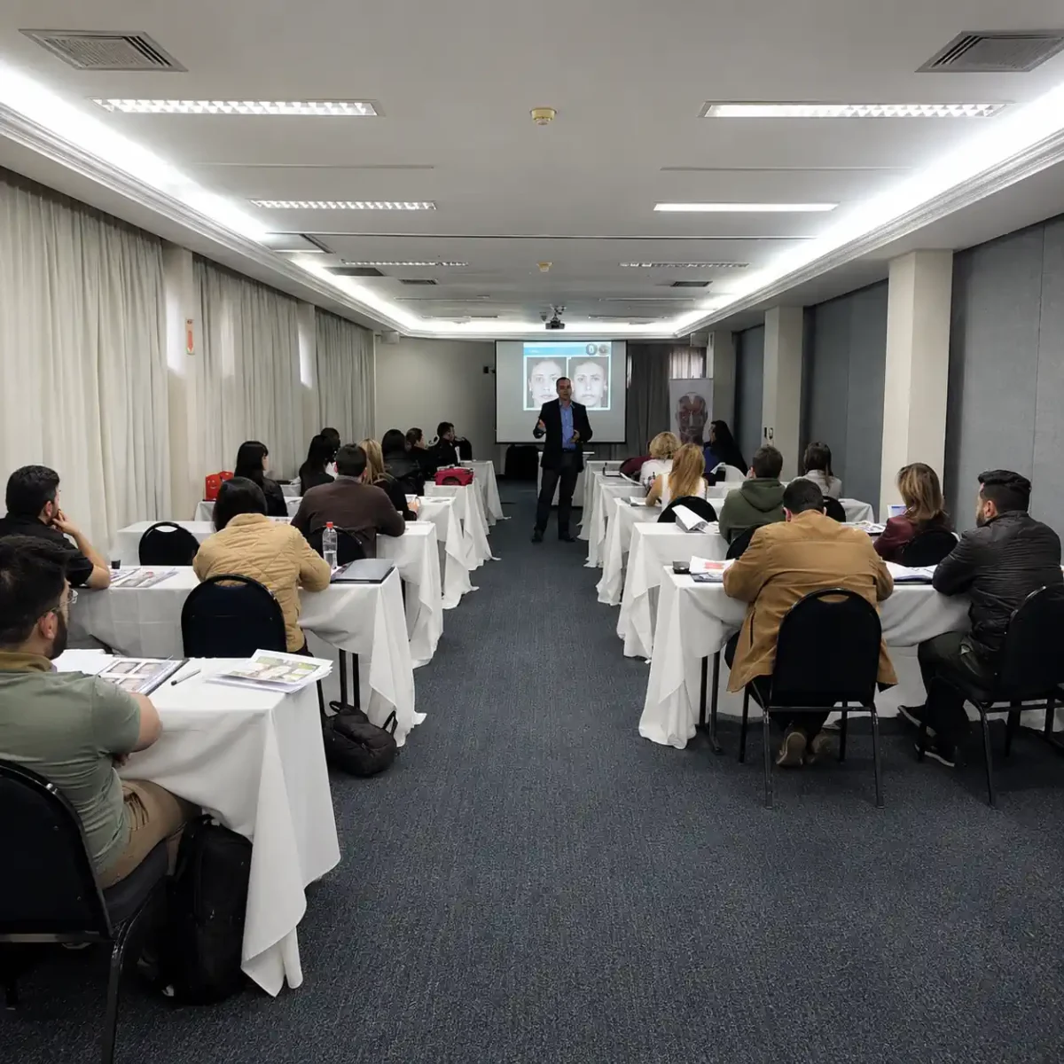 Turma acompanha apresentação sobre expressões faciais durante curso presencial do IBRALC.